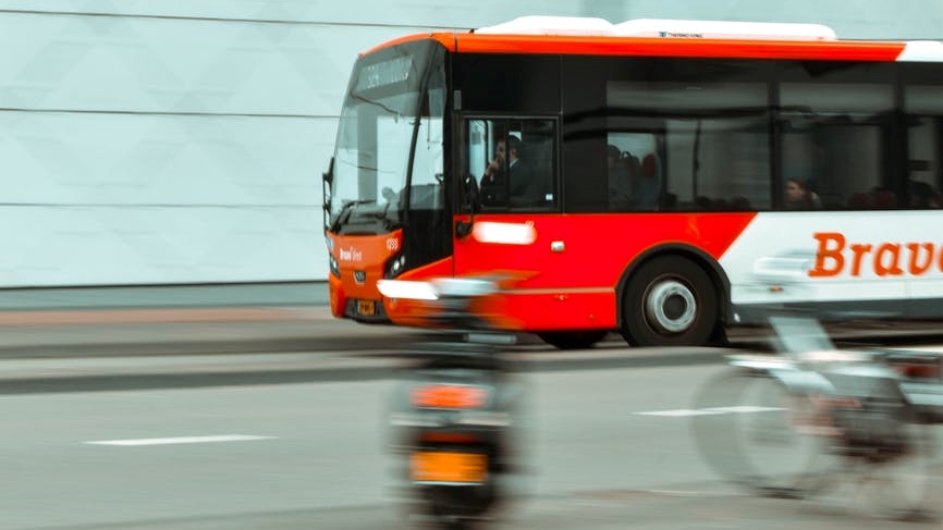 selective focus photography of red and white bus